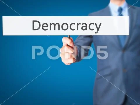 Democracy - Business man showing sign Stock Photos