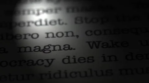 Democracy dies in denial. Moving text printed on a page. Slow motion. Stock Footage 307286169
