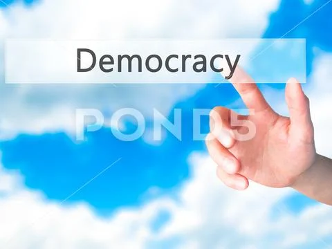 Democracy - Hand pressing a button on blurred background concept Stock Photos
