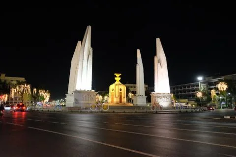 Democracy Monument located at the intersection of the streets of the night city. Stock Photos