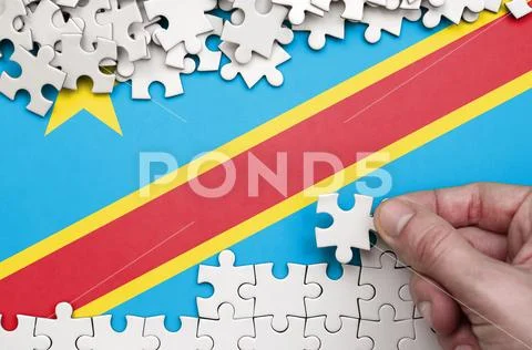 Democratic Republic of the Congo flag is depicted on a table on which the hu Stock Photos