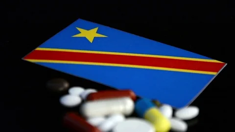 Democratic Republic of the Congo flag with lot of medical pills isolated Stock Footage 77381304