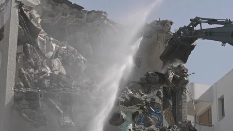 Demolishing the Side Wall of an Old Building with an Excavator Stock Footage 311285791