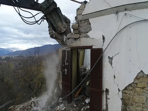 Demolition of a building badly damaged by an eartquake from a drone Stock Footage 112662401