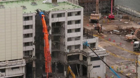 Demolition of building in progress, high reach shears snap off and break roof Stock Footage 130285828