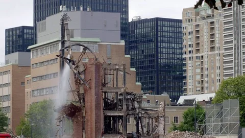 Demolition claw pulling brick building apart 4K Stock Footage 97610336
