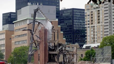Demolition claw pulling down last of building 4K Stock Footage 97610342