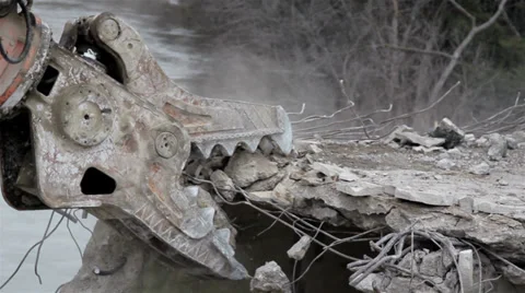 Demolition equipment crunching the concrete in the bulldozer destroying a Stock Footage