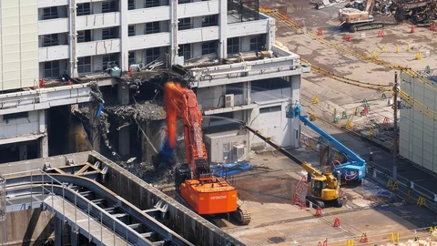 Demolition excavator use shears to cut down wall and floor slab, time lapse shot Stock Footage 129634341