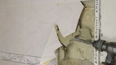 Demolition Hammer Breaking the Tiled Wall Stock Footage 110703374