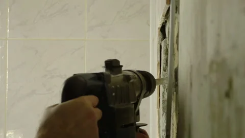 Demolition Hammer Breaking the Tiled Wall Stock Footage 119020232