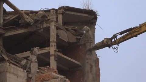 Demolition of a multi-storey building with hydraulic shears, for future devel Stock Footage 109418929