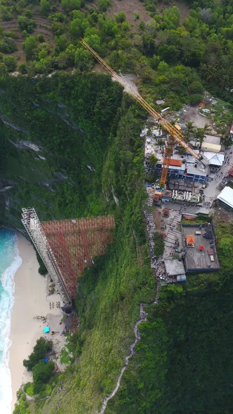 Demolition-Ordered Elevator and Crane at Kelingking Beach, vertical orbit shot Stock Footage 342697270