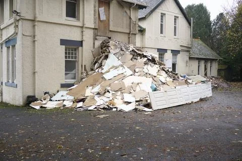 Demolition in progress of derelict house on construction building site Stock Photos