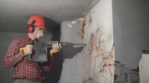 Demolition service. worker with hammer breaking interior wall Stock Footage 131397795