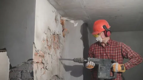 Demolition service. worker with hammer breaking interior wall Video stock 131397802