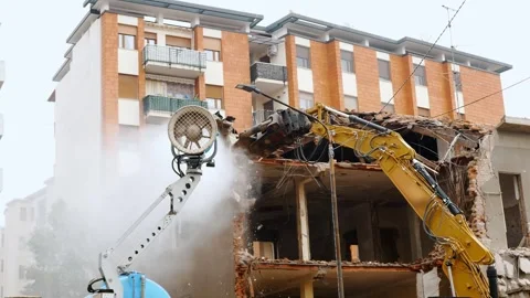 Demolition of Urban Building Using Heavy Machinery in Daytime Stock Footage 276017680