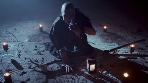 Demonic Monk in a Satanic Ceremony drinking a liquid from the bottle Stock Footage 259787750