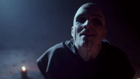 Demonic Monk in a Satanic Ritual calling the devil with a ritual staff and .. 스톡 동영상 259783790