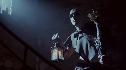 Demonic Monk in a Satanic Ritual calling the devil with a lantern Stock Footage 259826828