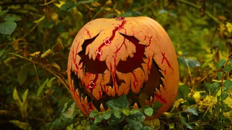 Demonic pumpkin bleeding with cursed grin among haunted forest shadows. Dreamy Stock Footage 318899274