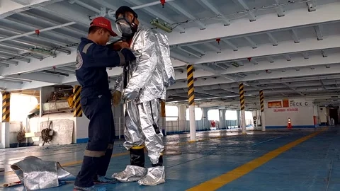 Demonstrate the fireman suit Stock Footage 213457811