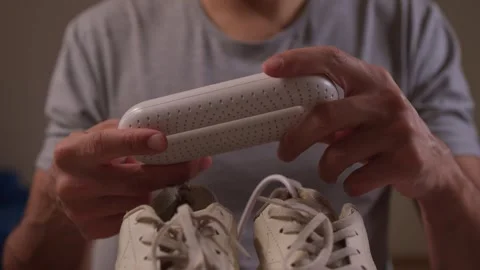 Demonstrating a Cleaning Tool for Sneakers While Showing it in Action and Stock Footage 317061330