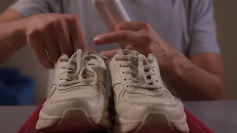 Demonstrating a Cleaning Tool for Sneakers While Showing it in Action and Stock Footage 317061362