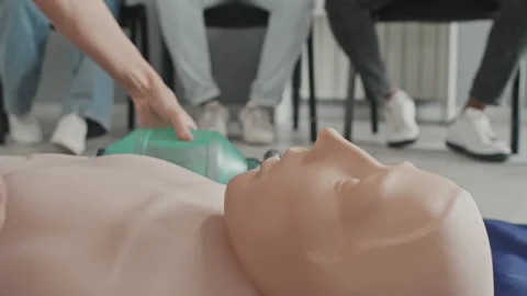 Demonstrating CPR Process Using Dummy Stock Footage 223940812