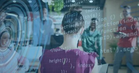 Demonstrating developer in pink blouse typing code with observers in office,  库存照片