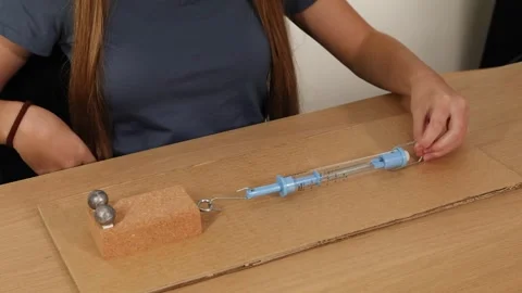 Demonstrating Friction and Force with Spring Scale Experiment Vídeos de archivo 307156970