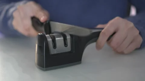 Demonstrating a Knife Sharpeners Effectiveness for Both Home and Professional Stock Footage 318544057