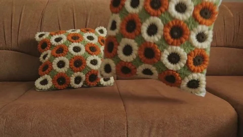 Demonstration the ability to crochet. Crocheted pillows put on the sofa. Stock Footage 80001379