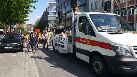 Demonstration against Monsanto, German sign, demonstrators walk behind truck Stock Footage