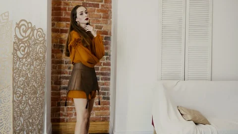 Demonstration of clothes, girl changes her poses in fashionable clothes stands Stock Footage 93541909