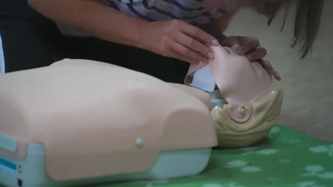 Demonstration of CPR technique using a d... | Stock Video | Pond5