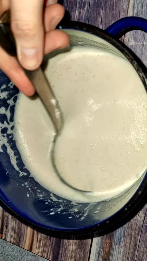 Demonstration of the finished dough for pancakes using a ladle Stock Footage 232945777