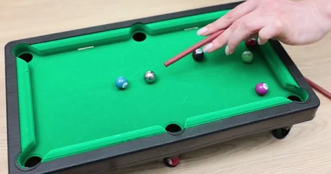 Demonstration of the game of mini-billiards on the table in a cozy atmosphere of Video stock 296674785