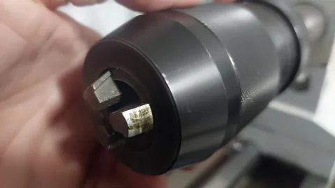 Demonstration of a keyless drill chuck mechanism on a lathe machine Stock Footage 335826677