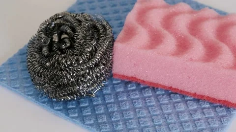 Demonstration of kitchen care products: kitchen sponge and metal sponge and abso Stock Footage 233353585