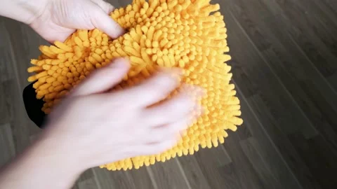 Demonstration of a microfiber car wash glove. Close-up. 4k video Stock Footage 231705080
