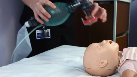 Demonstration of oxygen mask technique with baby manequin Stock Footage 87457953