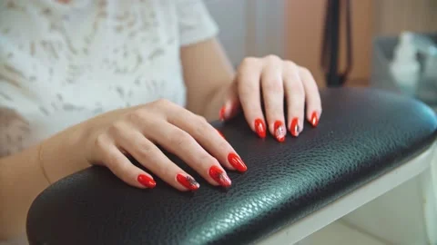 Demonstration of painted nails, red paint and varnish. Stock Footage 152988221