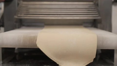 A demonstration video of the dough sheeter machine in work. Viennoiserie dough Stock Footage 106381623