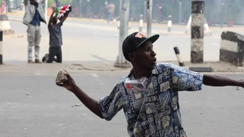 Demonstrator throws stones. 스톡 동영상 311483634