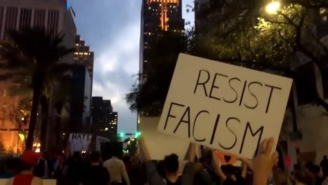 Demonstrators activist arms hands marching and carrying sign Resist Fascism Stock Footage 73127774