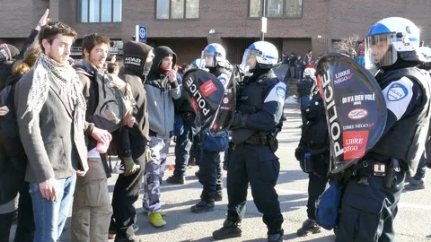 Demonstrators being pushed back by riot police with batons and shields Stock Footage 109131511