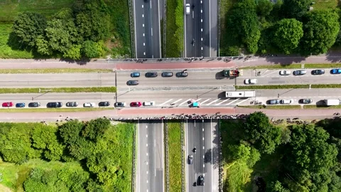 Demonstrators block traffic on a bridge, letting a red car pass Stockbeeldmateriaal 314070919