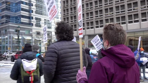 Demonstrators carry placards at protest. Stock Footage 317554236