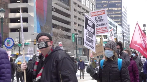 Demonstrators march to protest union-busting practices of Amazon. 스톡 동영상 317554496
